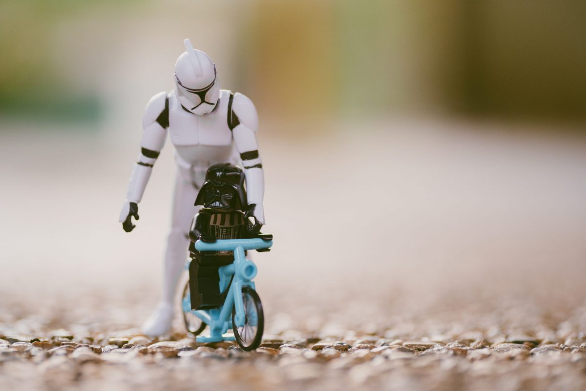 Stormtrooper and mini darth riding a bike