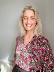 Jenny Warwick, smiling warmly, professional headshot